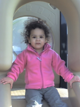 Bridget  on slide at the park age 3