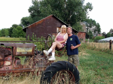 09-144--Marshan & I,pose on vintage tractor ne