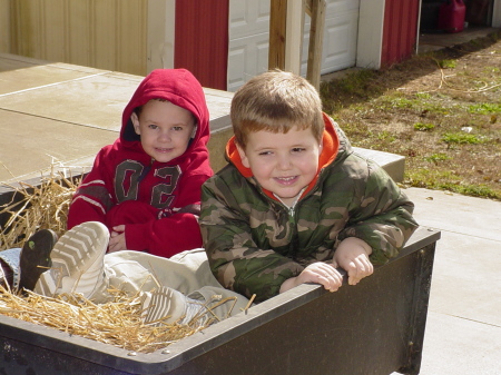 boys on a hay ride getting pumpkins