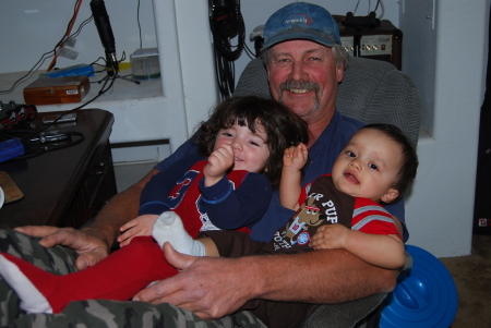 My husband with 2 of our Grandkids
