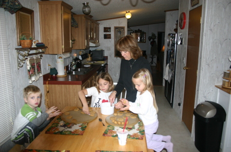 3 of 5 grandkids making cookies with Nana