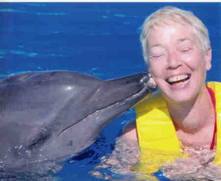 elsa being kissed by a dolphin