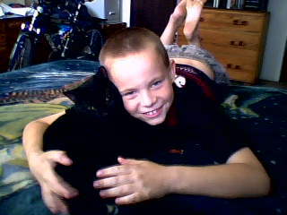 My son Zodd with our Blackie the cat