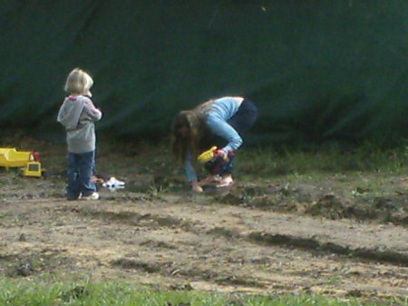 Emily And Nana Collecting toy's out of mud