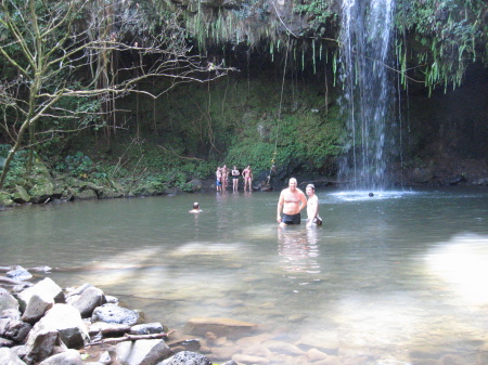 Father and son enjoying a hidden waterfall.