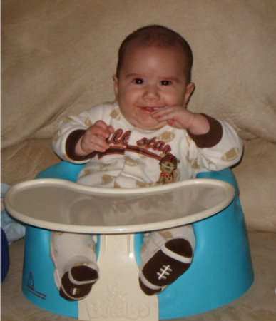 Happy in his Bumbo seat.