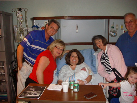 Proud Grandparents, mother, baby & daughter