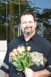 Uncle Tom holding Sydney's Graduation flowers