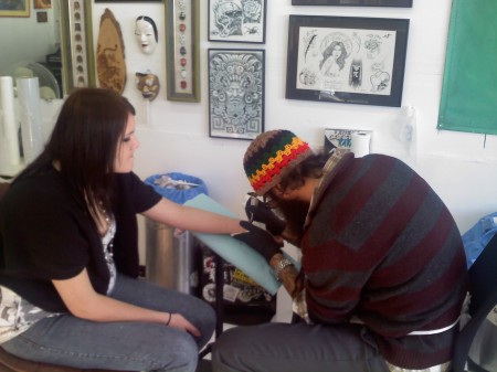 Izzy getting commemorative tattoo