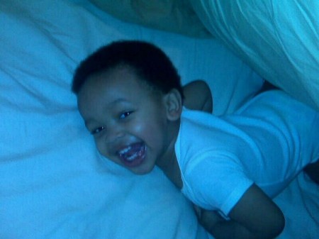 Cam playing in the bed.