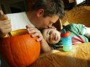 My son and grandson carving a pumpkin