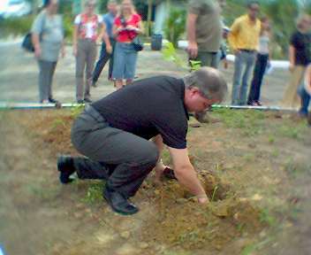 Alan planting a tree at a conservation project
