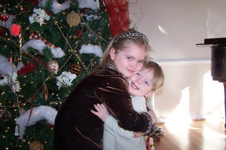 grandchildren in front of Christmas tree