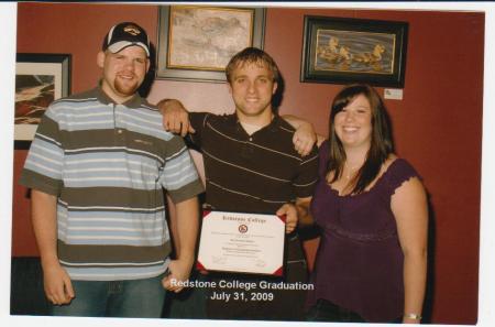 roy graduation , with david bro, and wife lind