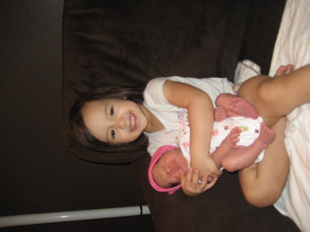 Caitlin the big sister holding Emma