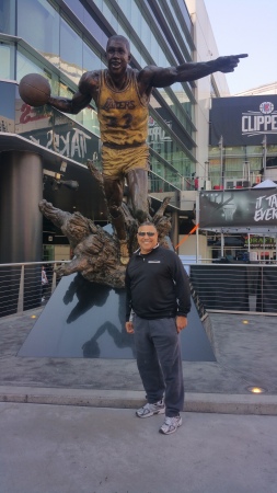 At Laker game, standing next to Magic's statue