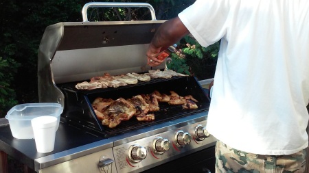 My son trying out his new grill