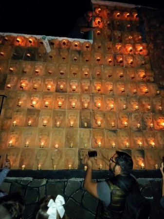 Lighting the wall of skulls, Day of the Dead