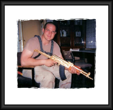 Oldest son in Iraq 2003 w/Sadam's gold AK47