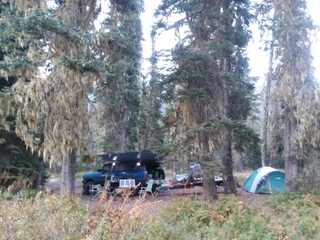 A typical truck camp with kayaks and quads