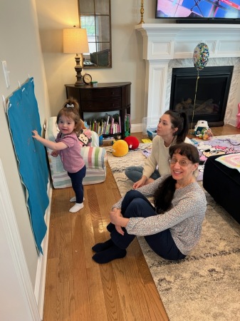 Grand daughter "teaching" her mother and me.