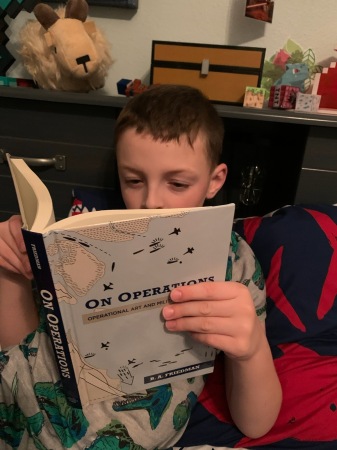 Logan “reading” my son’s latest book