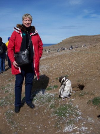 Laurie with a Penguin friend in South America