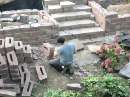 Lion Man building retaining walls in backyard