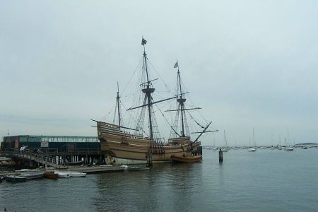 The Mayflower next to Plymouth Rock.