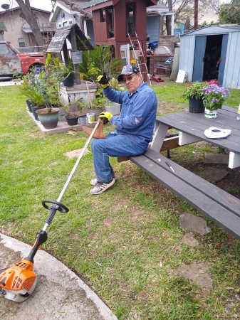 My husband cutting the grass