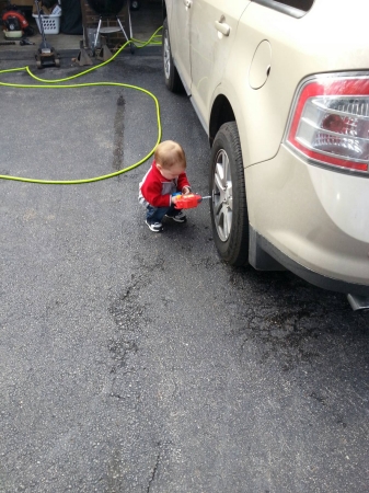 Cam helping Daddy rotate the tires.