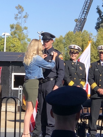 Jennifer pinning Matt at OCFD Ceremony 