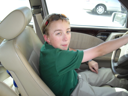 My boy trying the drivers seat in my car.