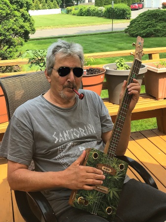 Relaxing on the deck with my guitar and pipe 