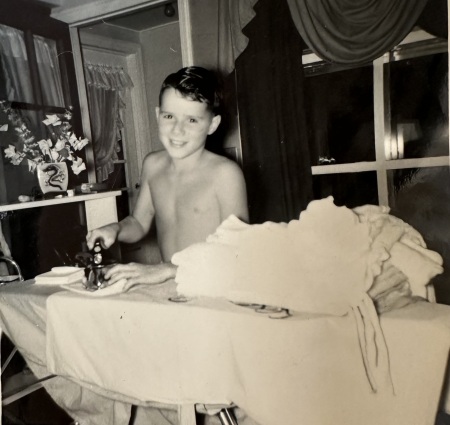 Bobby ironing clothes for my mom, 1955.