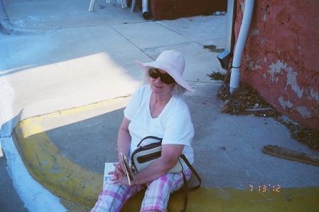 JoAnn on the curb at the Peach festival