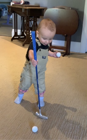 River teaching Grandpa how to putt