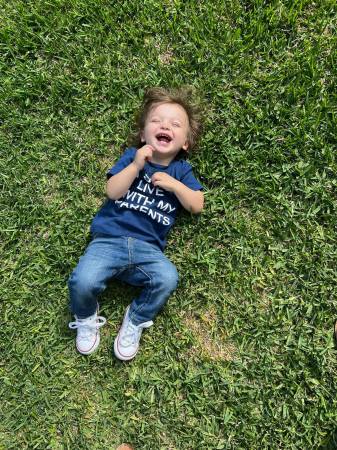 Silas laying the grass soaking up some sun