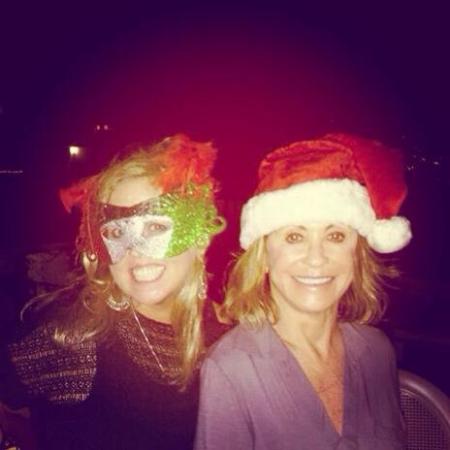 Daughter, Aimee and I in mask and santa hat.