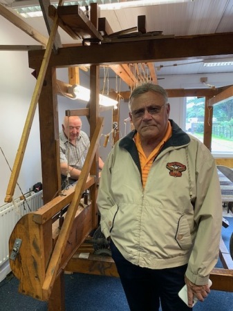 A wool maker on a 100 year old wool machine.