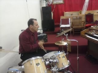 Playing drums for the praise and worship team.