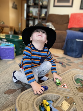 He likes to wear grandpa’s hat. 