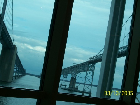 Ship is between the eastbound and westbound portions of the bridge.