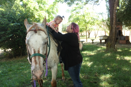 mY DAUGHTER TAKING HER DAUGHTER OFF HER HORSE 