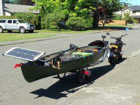 Solar electric boat in tow with 50 cc scooter
