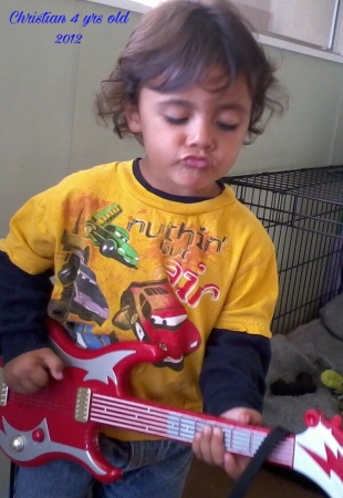 Christian rocking out with his first guitar..