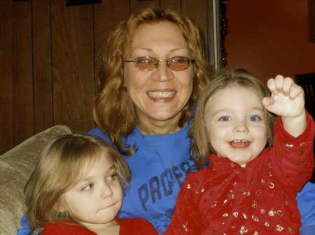 Me and my two youngest granddaughters; three years ago. That is Maddie (Madison) on my R. and Scarlet on the L. and my daughter Tara making me laugh. Dec. 2011