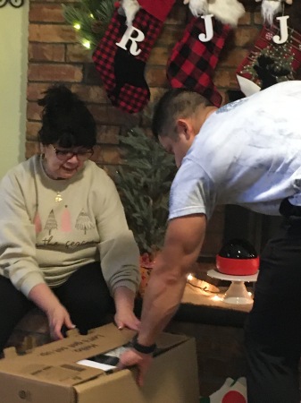 Helping mom open her presents 