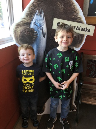 My grandsons standing in front of a local bear