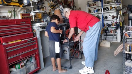 My nephew Levi helping his great-grandfather.